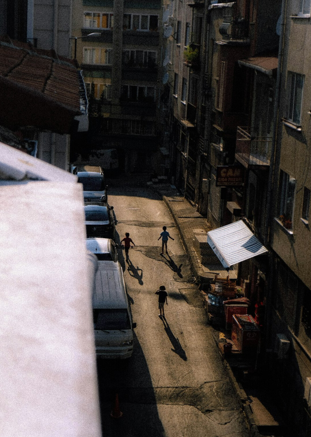Children playing football on a narrow city street in Chile
