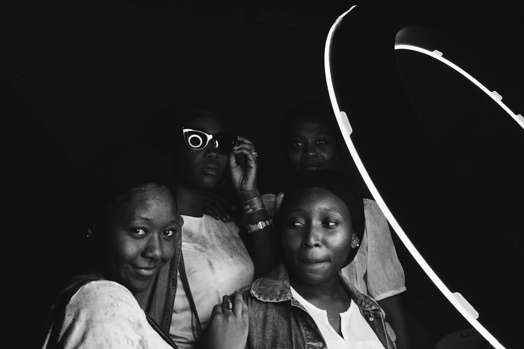 Group portrait of four documentary photographers with cameras