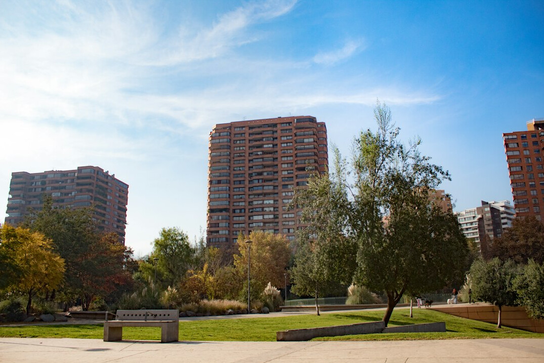 Public plaza in a Chilean city with people resting on benches