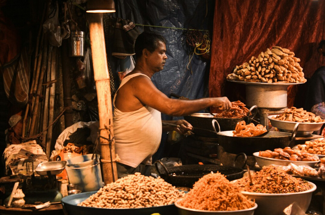 Street market vendor arranging fruit on a wooden cart in Chile