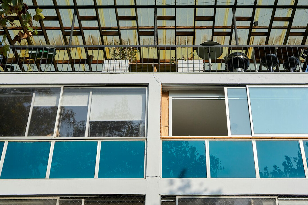 Contrast between a colorful old facade and a glass building in Chile